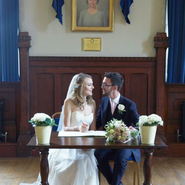 Wedding couple signing the wedding licence