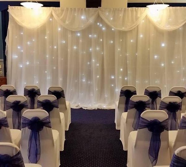 Fairy light screen at front of wedding set up in ground floor room